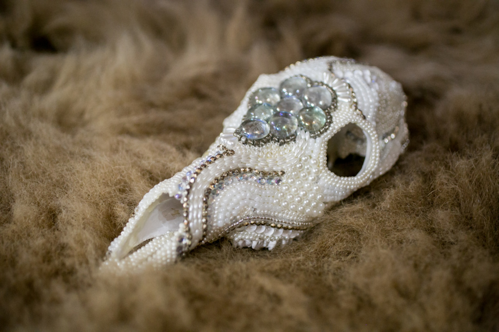 Whitetail Doe, White Beaded Skull on a fur rug.