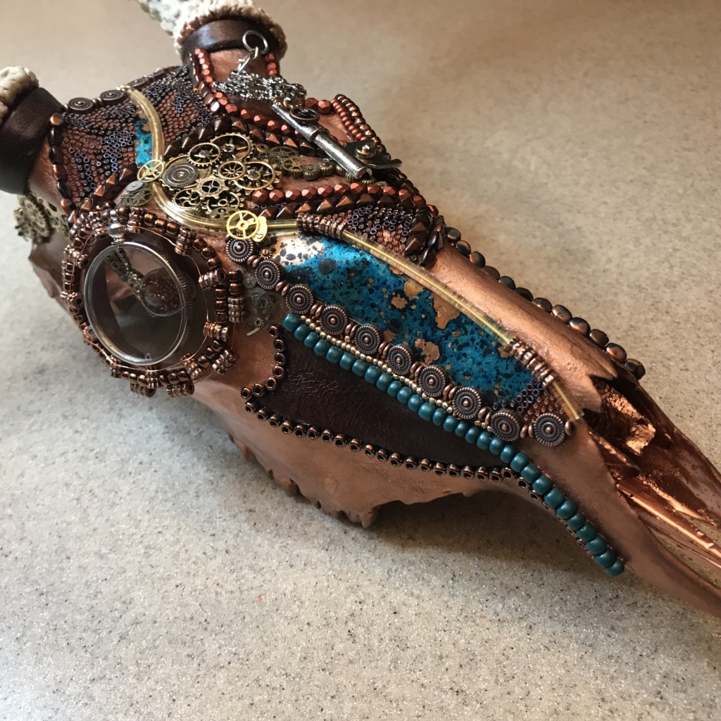 The continued beading process and naming of Grand Chaos, Steampunk buck skull art piece. 