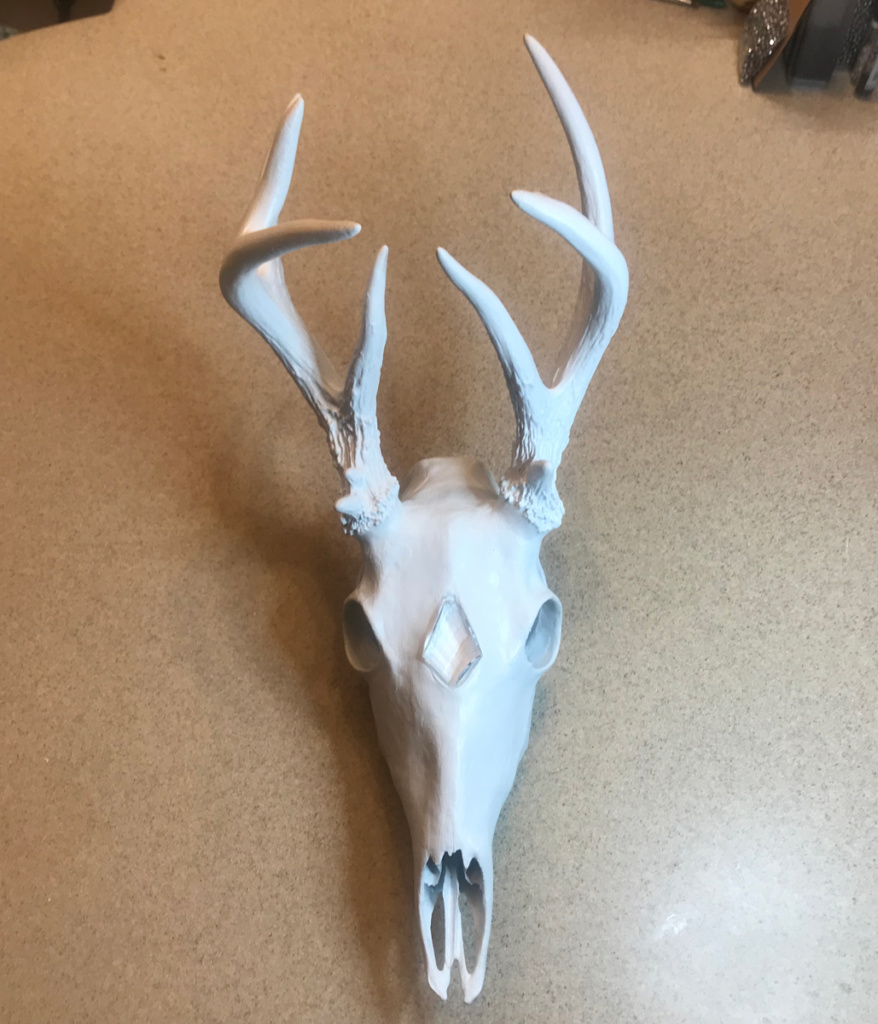 Whitetail buck skull art piece after the clay and paint stage.